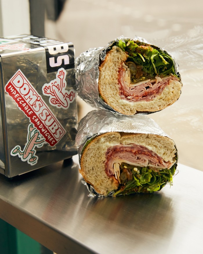 The Spicy D sandwich at Dom’s Subs, wrapped in tin foil and filled with rolls of Italian red salami, salami napoli, ham and provolone