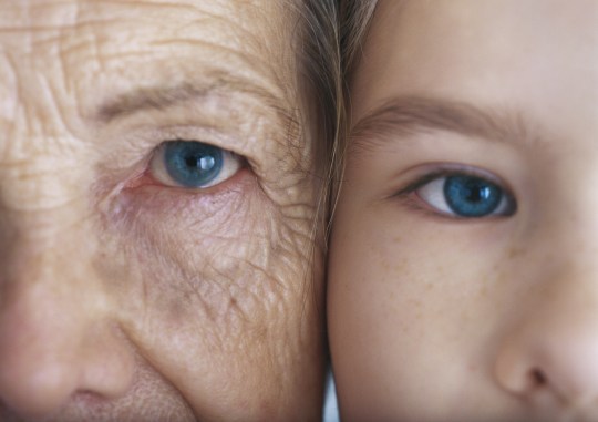 Girl and grandmother cheek to cheek