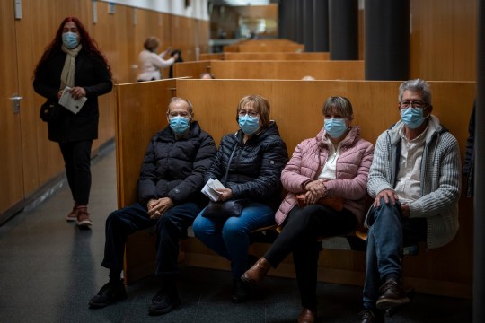 People wearing face masks as a precaution wait for a doctor appointment inside a hospital in Barcelona, Spain, Monday, Jan. 8, 2024. Regional and national health chiefs are meeting Monday to decide whether to extend mandatory mask???wearing to all health facilities following an epidemic outbreak of flu and other respiratory viruses that are putting a strain on the system. (AP Photo/Emilio Morenatti)