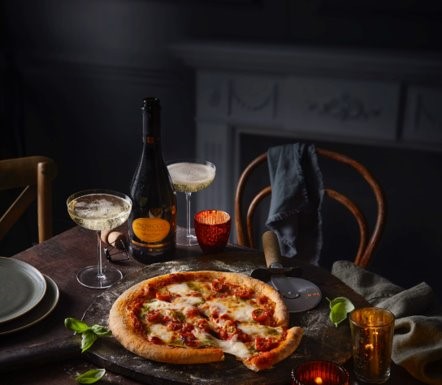 It includes authentic Italian pizza and a bottle of fizz,