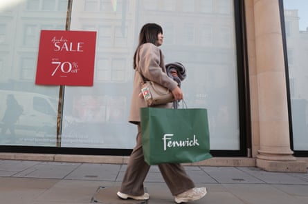 A shopper walks past Fenwick’s on Bond Street.