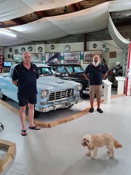 Tony Galea and Mark Galea with their dog Millia inside the National Holden Motor Museum.