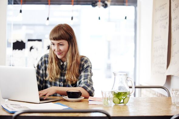 Girl working on laptop in a coffee shop