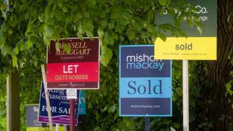 Estate agent signs outside an apartment block in Brighton, East Sussex