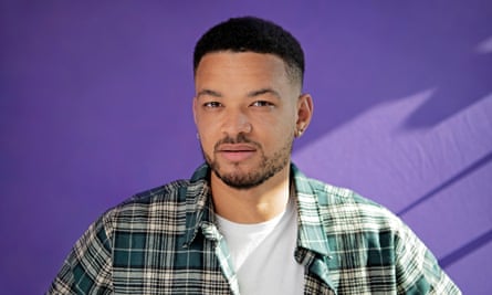 Portrait of Steven Bartlett in a plaid shirt against a purple background