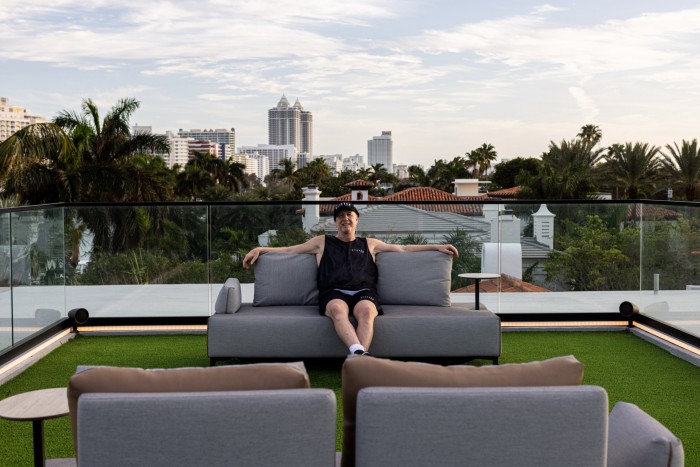 Marc Roberts sitting on a sofa on the terrace of his home