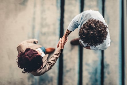 two people shake hands, viewed from above