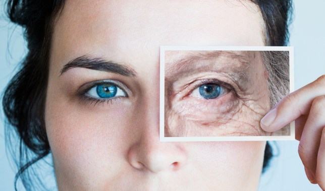 Young woman with photo of aged eye over her own