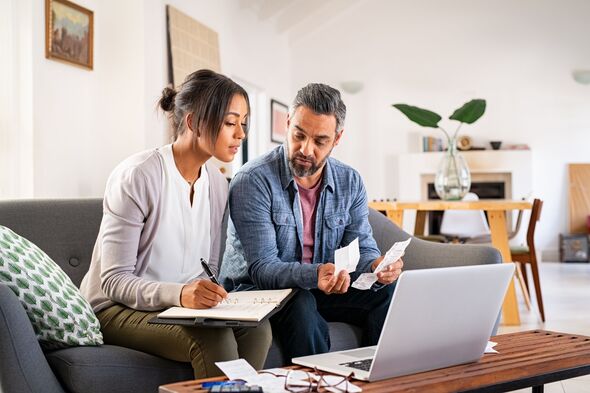 Couple calculating finances at home