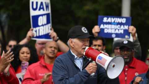 Joe Biden wearing a hat and speaking through a megaphone