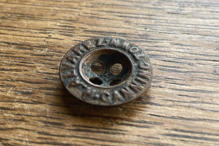 A mudlarking button