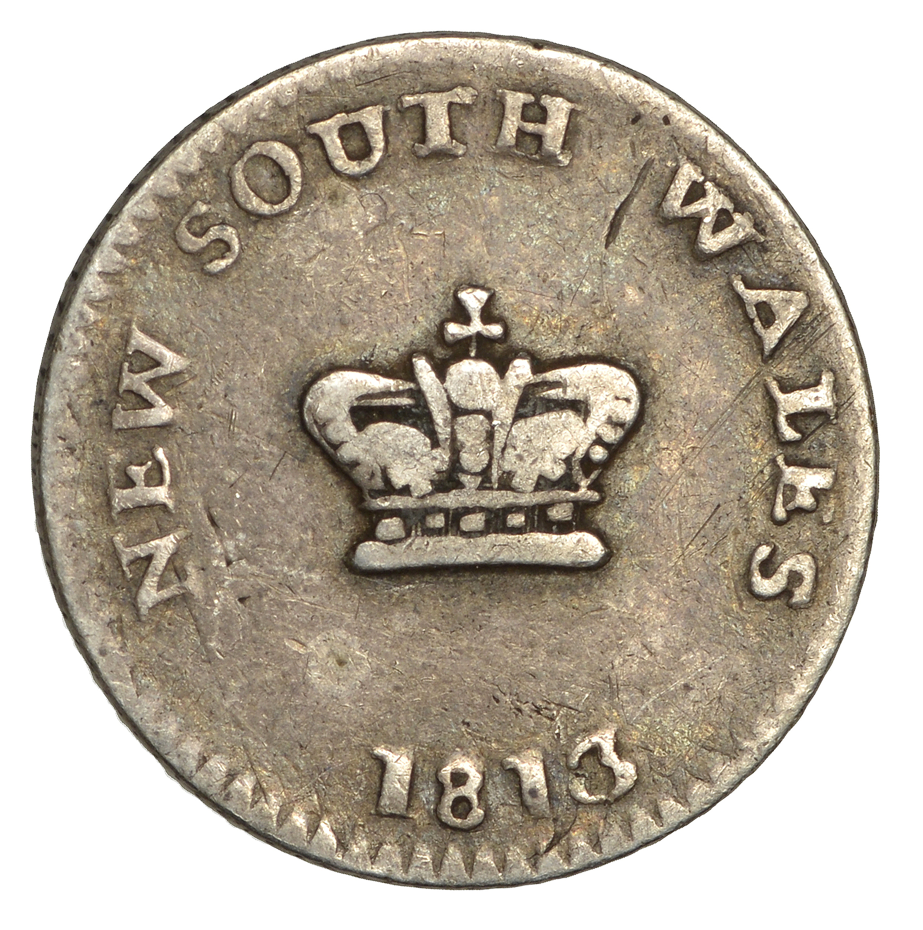 The coin says 'New South Wales 1813 Fifteen Pence' after its Australian origins