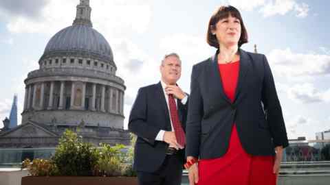 A man and a woman stand in front of cathedral