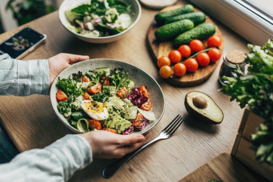 Woman with a delicious superfood salad 