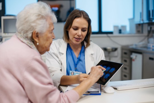 Woman over 65 looking at brain scan results