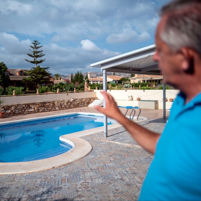 Mark Daniel, former councillor and estate agent, shows a pool at a a typical property that a British expat will buy