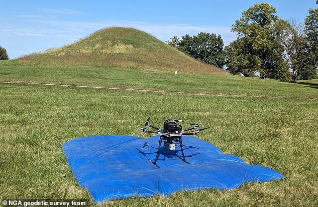 Above an NGA drone equipped with a Light Detection and Ranging (LiDAR) scanner perched for takeoff on a tarp within the Cahokia Mounds Historic Site in Illinois