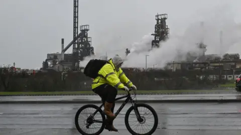 Getty Images A man cycles past the Port Talbot steelworks