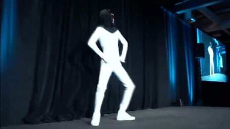 Elon Musk unveils plan for 'Tesla Bot' with man dancing in a bodysuit – video