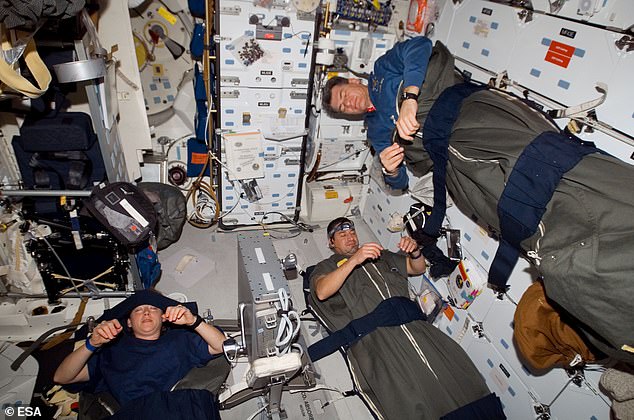 An astronaut's day on the ISS begins at 6:00 am GMT with a wake-up call from mission control. Pictured: astronauts Pam Melroy (left), George Zamka (bottom right),  and European Space Agency's (ESA) Paolo Nespoli as they sleep on the ISS