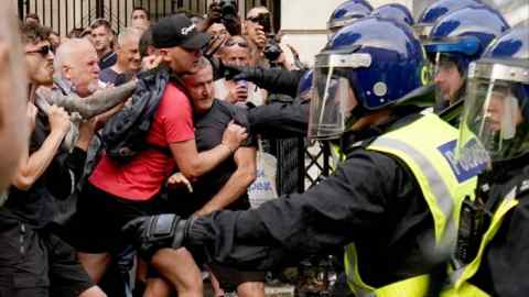 Police officers clash with protesters in Whitehall, London, on Wednesday