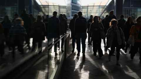 Commuters make their way to work in Manchester city centre