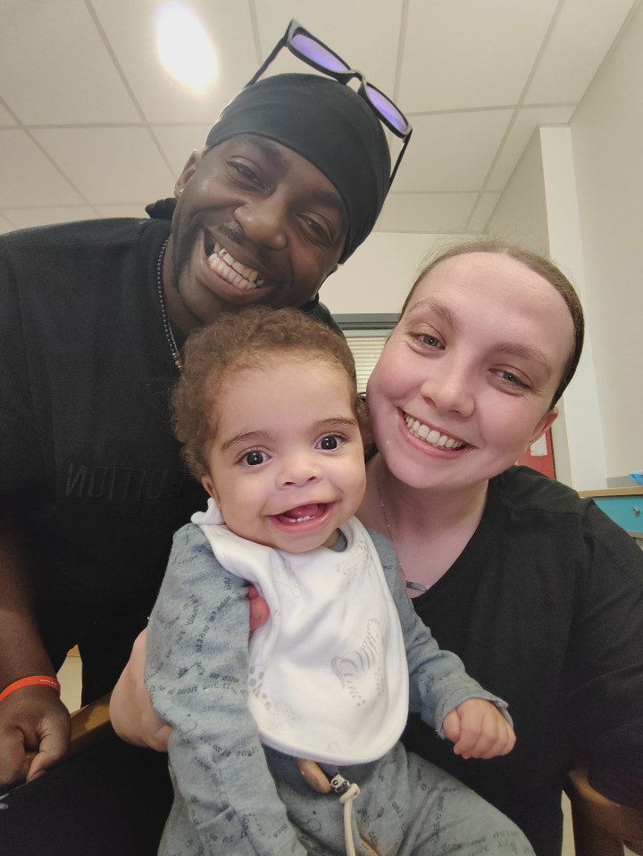 River with beaming parents Roseann and Rudy