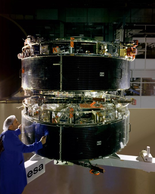 A technician inspecting the CLUSTER-2 in IAGB's assembling room, in Munich in 2000 before the satellites went into orbit 