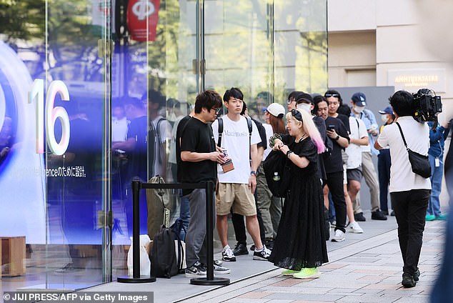 TOKYO, JAPAN: In Japan's capital city, a queue goes down the side of the Apple building and out of sight on Friday morning