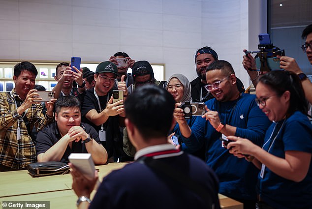 KUALA LUMPUR, MALAYSIA: An early customer faces the press in Kuala Lumpur. Across the world, the first customer through the door on iPhone release day is usually photographed and interviewed