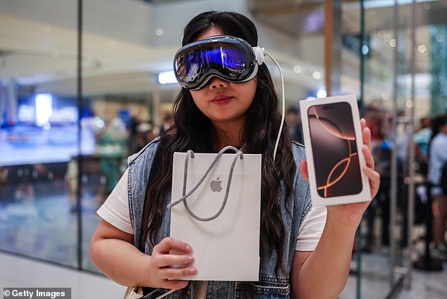 KUALA LUMPUR, MALAYSIA: Jena, 25, poses with a newly purchased iPhone 16 while wearing a Apple Vision Pro inside the Apple Store at Tun Razak Exchange (TRX), Kuala Lumpur