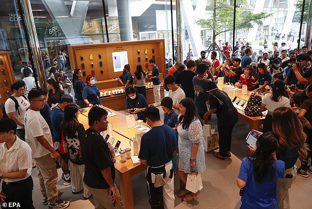 BANGKOK, THAILAND: Business as usual for Apple in Thailand as fans swarm over the new device