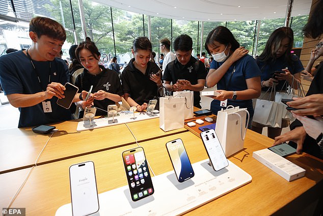 BANGKOK, THAILAND: Staff help members of the public choose their new iPhone. iPhone 16 is widely available for purchase in Thailand with a cheaper price tag than the previous iPhone 15 model, resulting from a stronger Thai baht against the US dollar