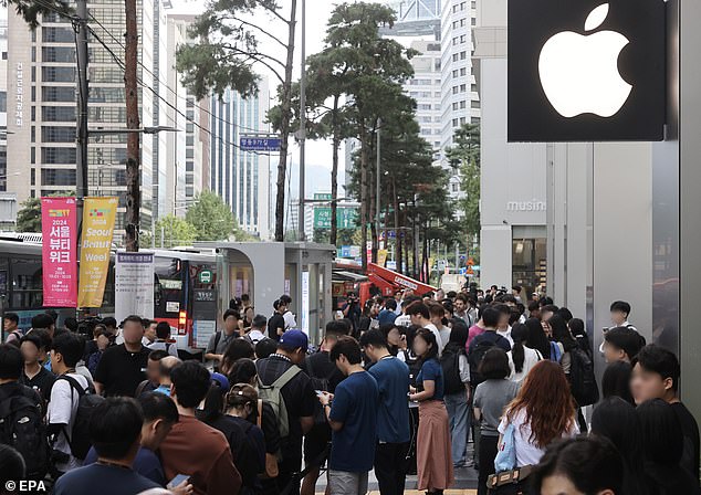 SEOUL, SOUTH KOREA: People line up in front of an Apple store in downtown Seoul, South Korea