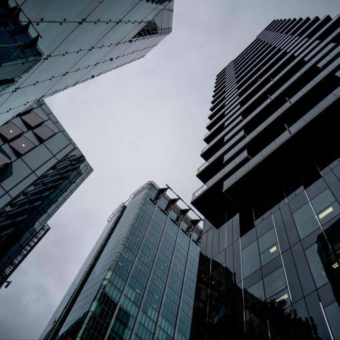 View from the ground looking up at the Citypoint building with grey clouds in the background