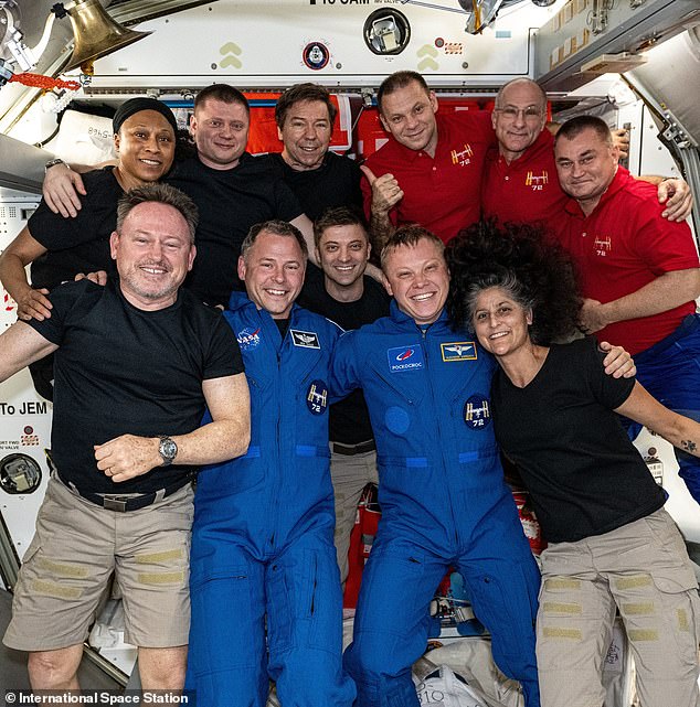 Wilmore (front left) and Williams (front right) pose with the other members of the Expedition 72 crew for a photo posted on October 4