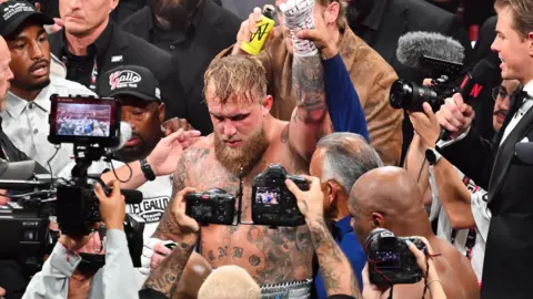 Getty Images Jake Paul defeats Mike Tyson during their heavyweight world titles of the Premiere Boxing Championship on Friday night at AT&T Stadium in Arlington, Texas, United States on November 15, 2024.