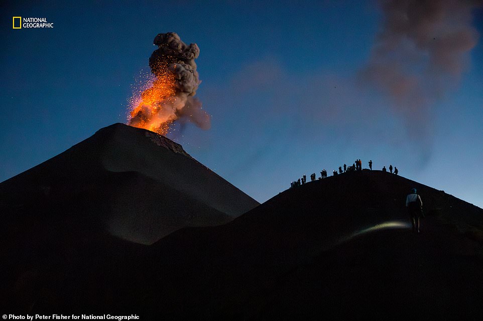 A mesmerising shot of Guatemala¿s Fuego Volcano, which has been erupting continuously since 2002. Nat Geo reveals: 'A one-day hike up its dormant twin, Acatenango, and across a valley rewards adventurers with a view from Fuego's ridgeline. Eruptions can occur multiple times a day'