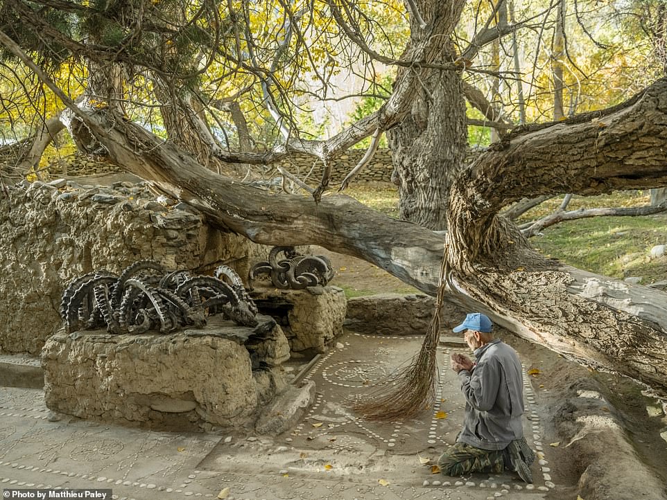 This thought-provoking image shows a shrine in an area with a rich history of animism, Zoroastrianism, and Buddhism that's maintained by local Wakhi people, who are Ismaili Muslims. Nat Geo explains that a tree that fell years ago on the shrine's tomb, adorned with horns from ibex and sheep, was left in place as custom dictates