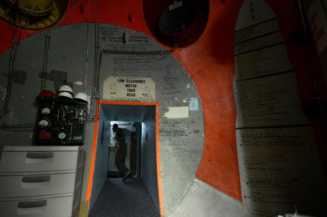 GREAT FALLS, MONTANA, 2014 - Missile combat crew member 2nd Lt. Wesley Griffith prepares to close a three foot thick door inside a launch control center at Malmstrom AFB. Located 70-ft. underground, the control centers were designed and built in the 1960's, during the peak of the Cold War. Malmstrom is home to hundreds of ICBM silos. (Photo by Robert Gauthier/Los Angeles Times via Getty Images)