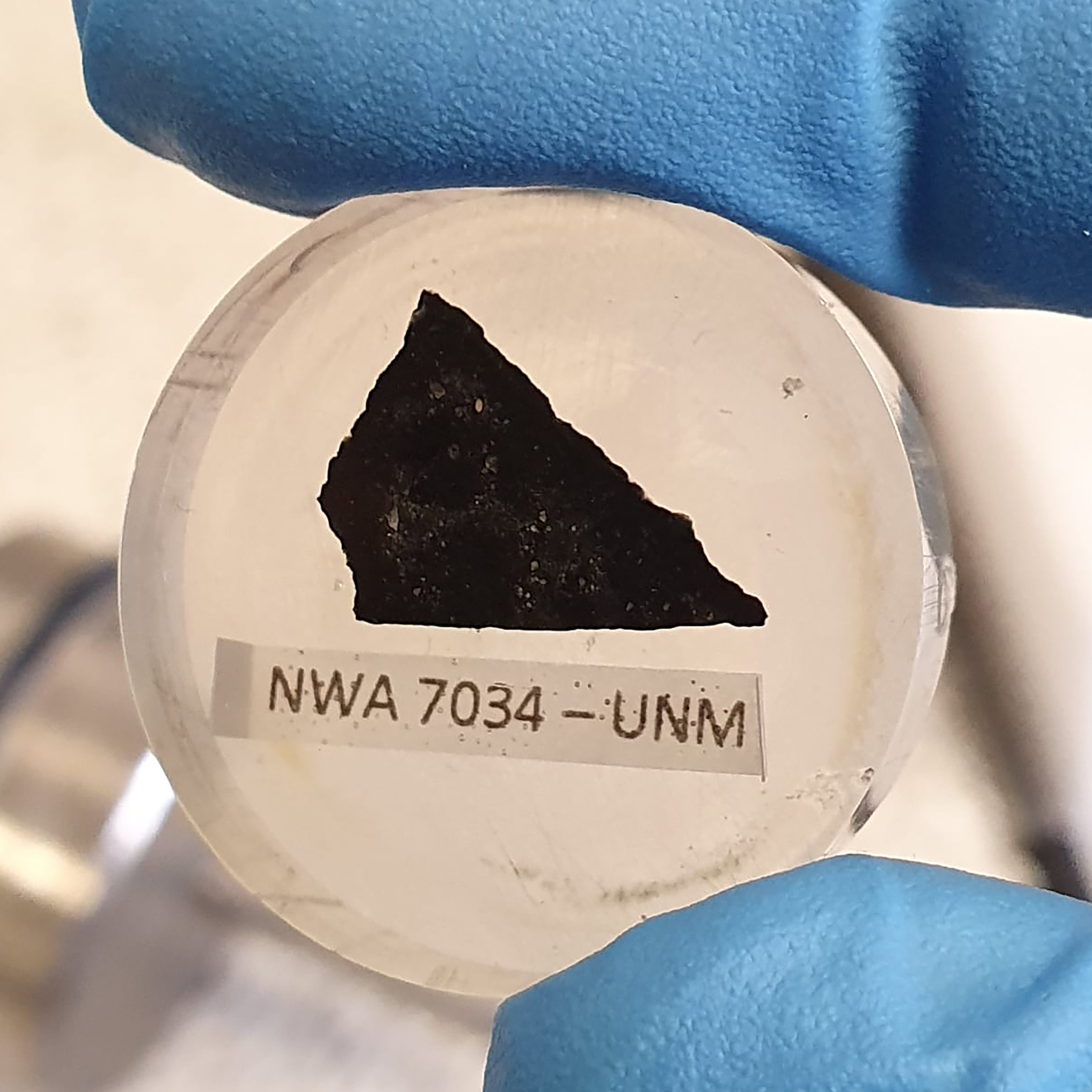 A sample of the Martian meteorite known as ‘Black Beauty’ is seen in this Curtin University photo. Black Beauty’s zircon grain was found to have ‘fingerprints’ of water-rich fluids