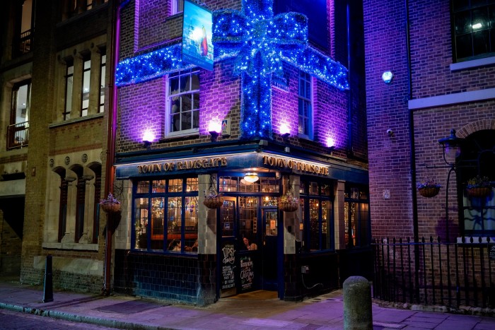 The Town of Ramsgate pub in Wapping, London, decorated with a giant blue bow of Christmas lights