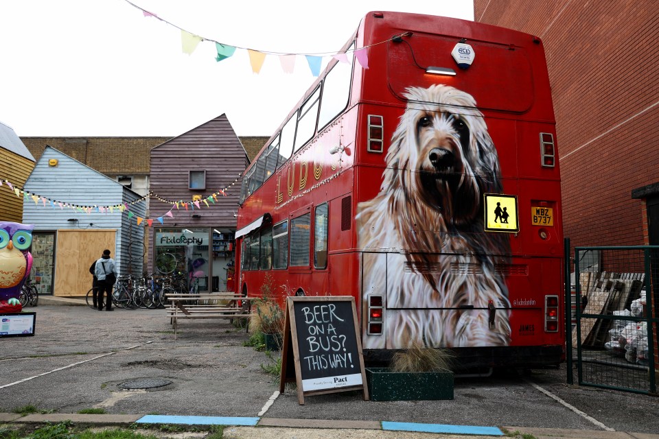 The rear of the bus features a mural of the couple's dog