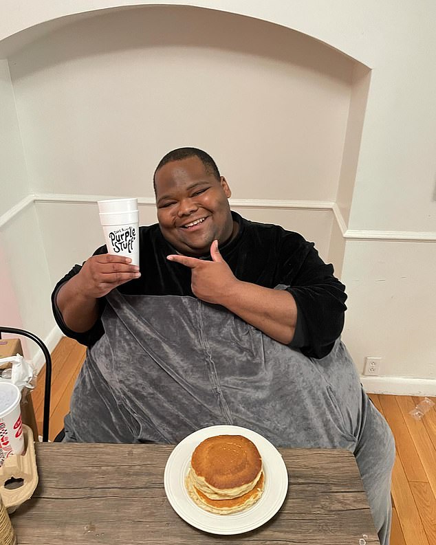 Blessing with one of his branded cups, which he sells online for $5