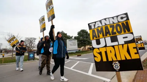 Getty Images Amazon delivery drivers walk the picket line outside Amazon delivery station as they went on strike in Skokie, Illinois on December 19 2024. 