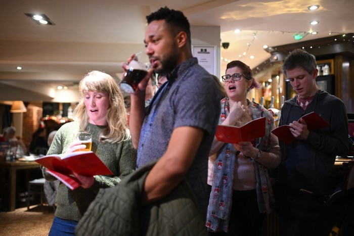 Carol singers perform at The Sportsman pub in Sheffield, UK