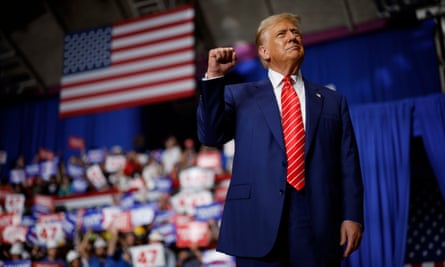 Donald Trump at a rally holding up his right fist