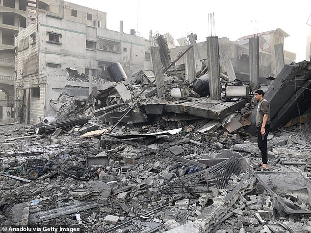 The Bulletin of the Atomic Scientists warned last year that the war between Israel and Hamas could spiral into a wider conflict in the region. Pictured: Homes in Gaza City reduced to rubble by an Israeli attack