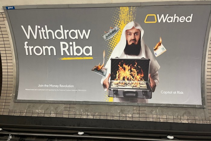 Wahed Invest’s poster showing a man holding a briefcase filled with burning US dollars and euros, next to the caption ‘Withdraw from Riba’